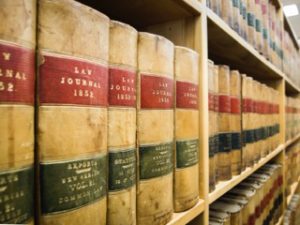 yellow law books line the wall of a library